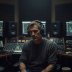 Portrait of Tomasz Lind, sound designer, in a dim studio
